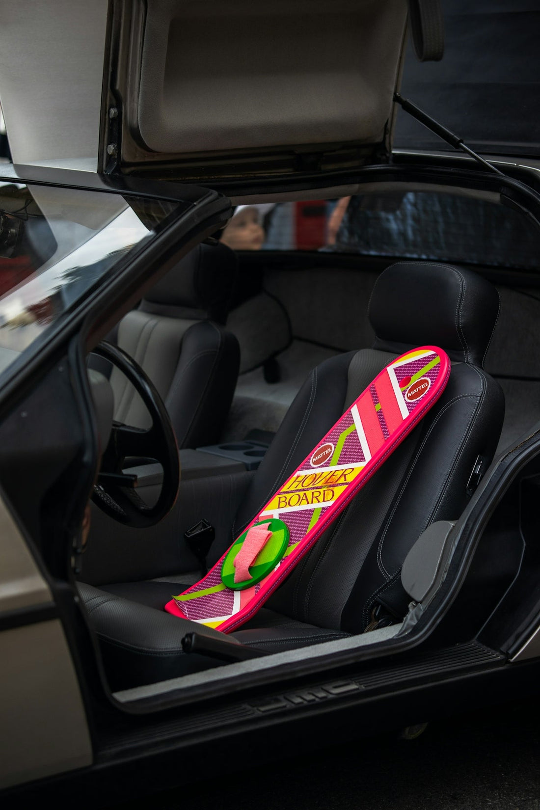 a pink snowboard sticking out of the back of a car